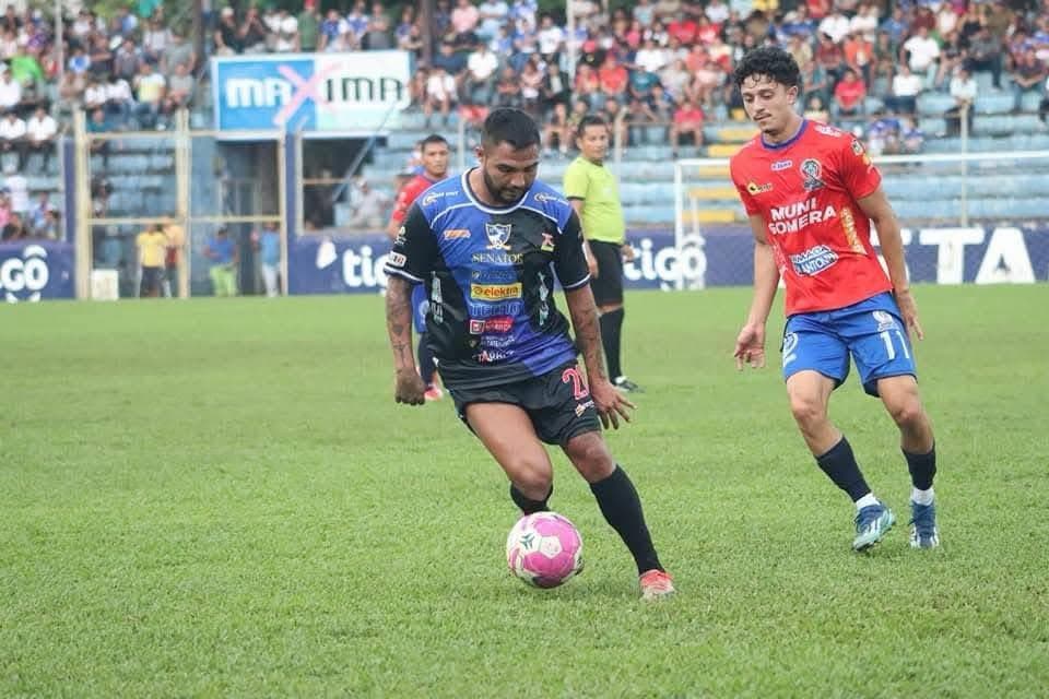 Soccer player carrying the ball during a match.